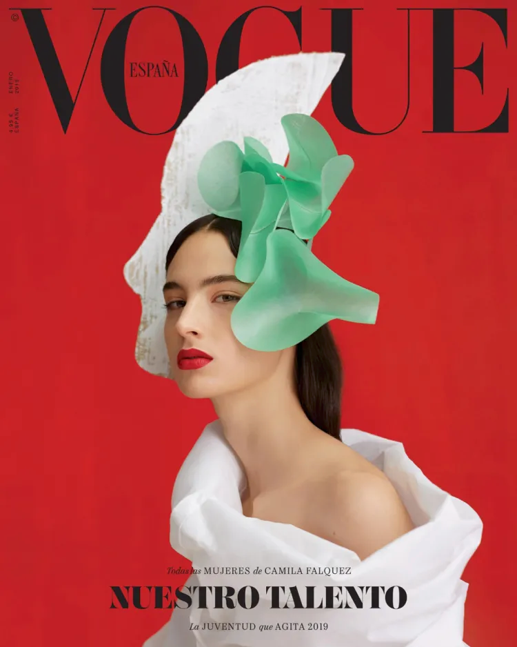 Vogue Spain Magazine cover with a red background and a model in a white geometric dress.